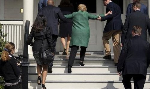 Hillary getting helped up stairs
