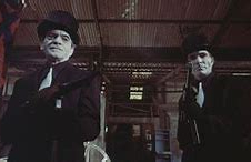 gray faced men with machine guns